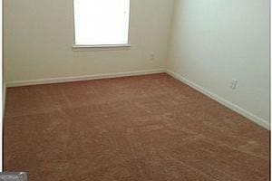 spare room featuring carpet floors