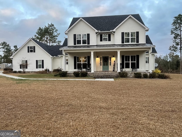 view of front facade with a front lawn and covered porch