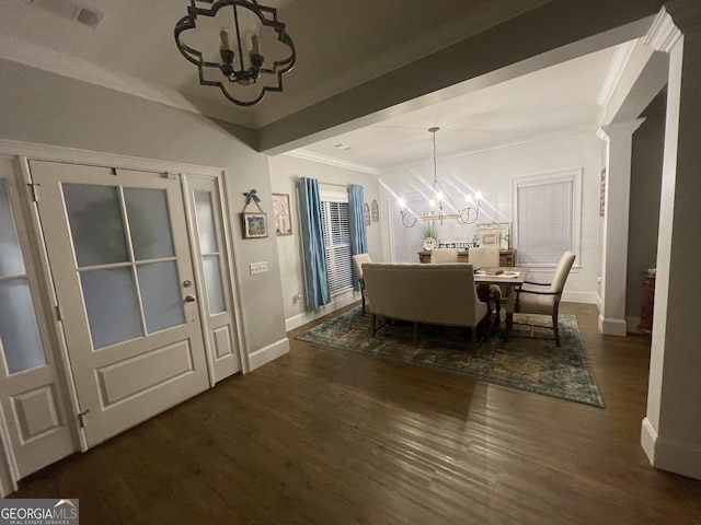 dining area with a notable chandelier, dark hardwood / wood-style flooring, and crown molding