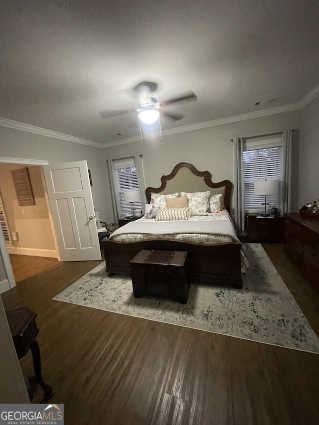 bedroom featuring ceiling fan, dark hardwood / wood-style floors, and ornamental molding