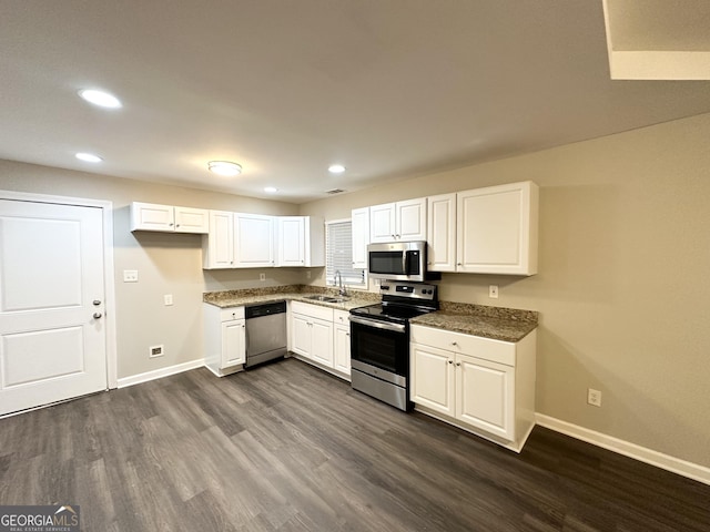 kitchen with stainless steel appliances, white cabinetry, dark hardwood / wood-style floors, and sink