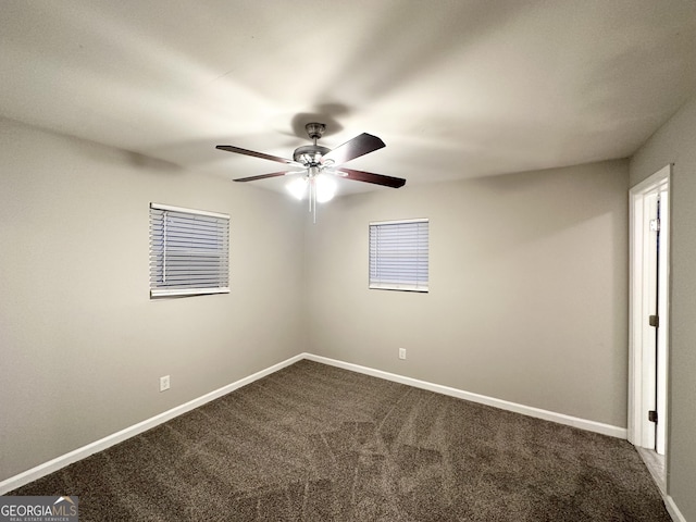 carpeted spare room with ceiling fan