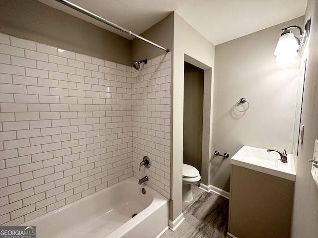 full bathroom featuring vanity, toilet, and tiled shower / bath