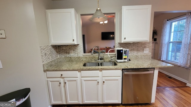 kitchen featuring white cabinetry, pendant lighting, and stainless steel dishwasher