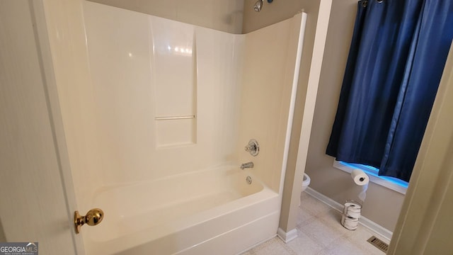 bathroom featuring shower / bath combination and toilet