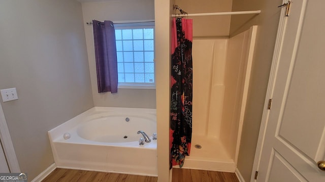 bathroom featuring hardwood / wood-style floors and shower with separate bathtub