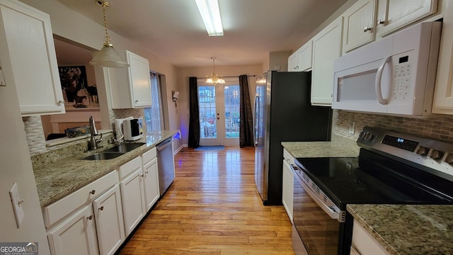 kitchen with white cabinetry, sink, decorative light fixtures, and appliances with stainless steel finishes