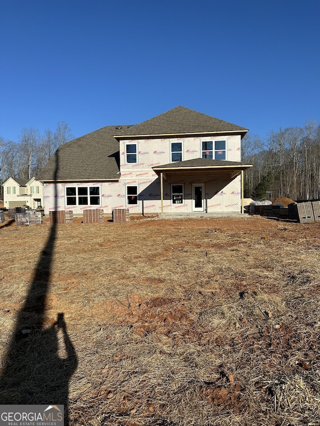 rear view of property featuring central AC