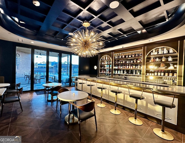 bar with a notable chandelier and coffered ceiling