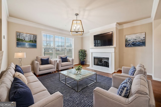 living room with crown molding, a chandelier, and hardwood / wood-style flooring