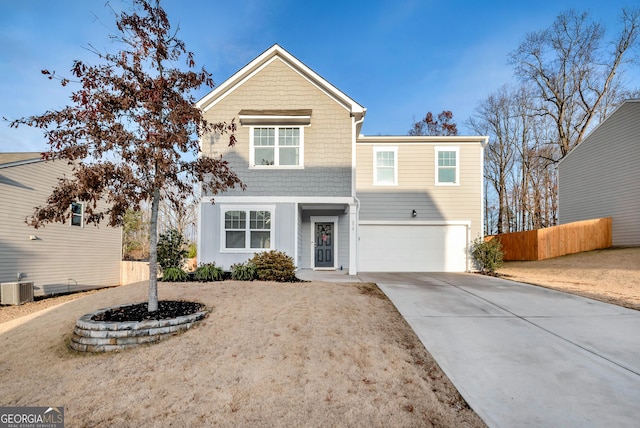 view of front of house with central AC, concrete driveway, an attached garage, and fence