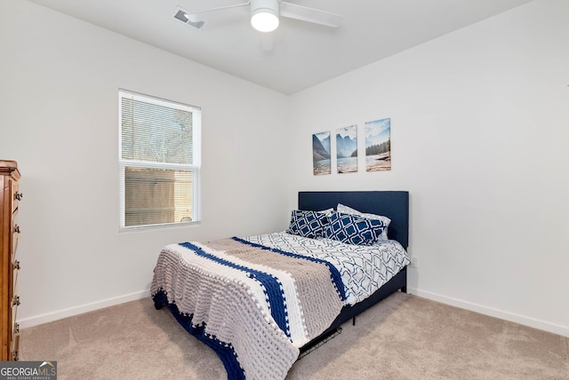 carpeted bedroom with visible vents, ceiling fan, and baseboards