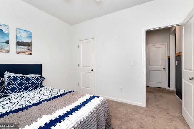 bedroom with light carpet and baseboards