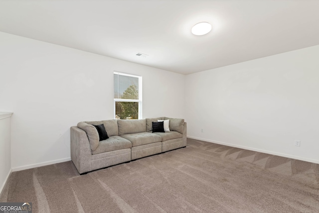 carpeted living area with visible vents and baseboards