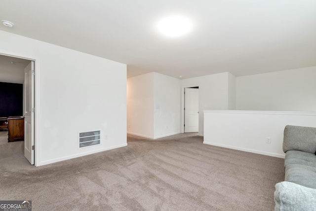 carpeted living room featuring visible vents and baseboards