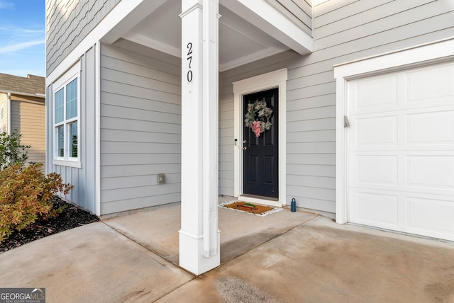 view of exterior entry with a garage