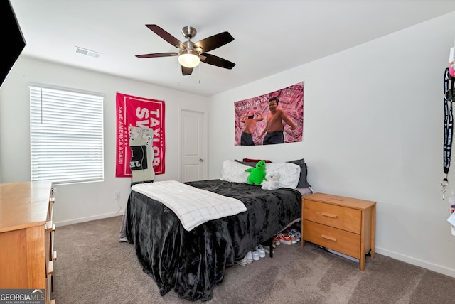 carpeted bedroom featuring visible vents, ceiling fan, and baseboards