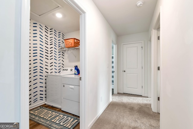 hall with baseboards, separate washer and dryer, and carpet floors