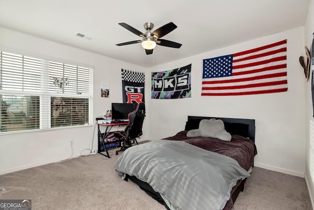 carpeted bedroom featuring visible vents, baseboards, and a ceiling fan