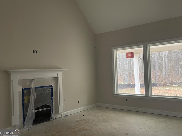 unfurnished living room with vaulted ceiling