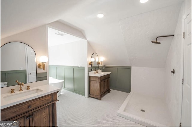 bathroom with vanity, walk in shower, and vaulted ceiling