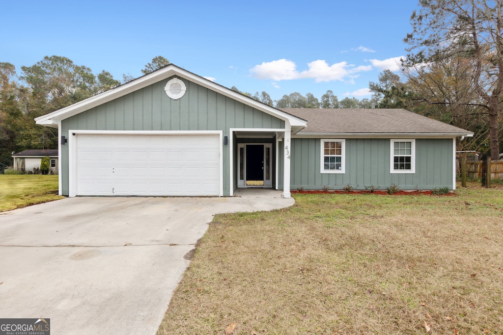 single story home featuring a garage and a front lawn