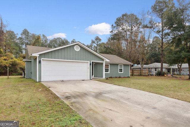 single story home featuring a garage and a front lawn