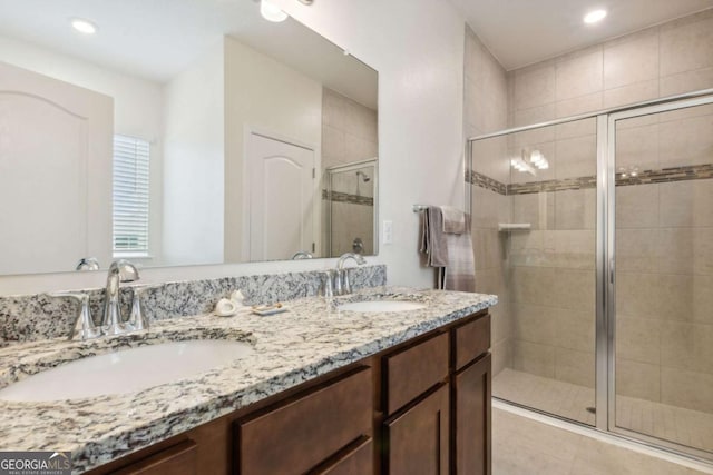 bathroom featuring vanity and a shower with shower door