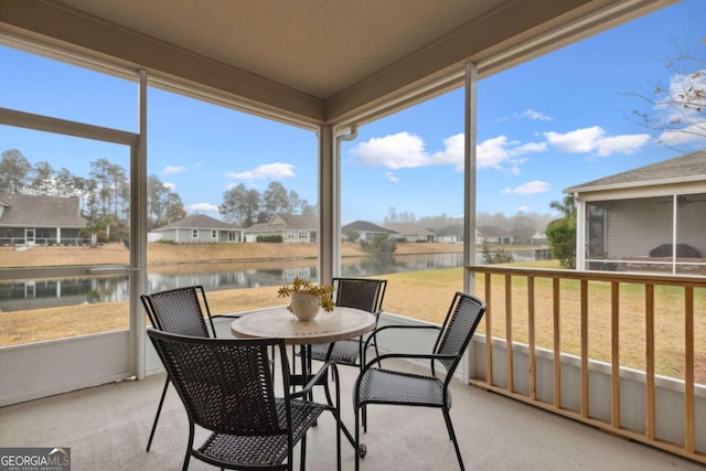 sunroom / solarium with a water view