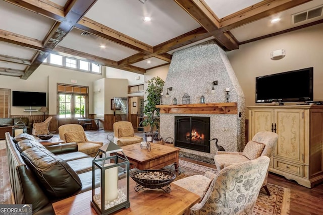 living room featuring coffered ceiling, wood-type flooring, a fireplace, and french doors