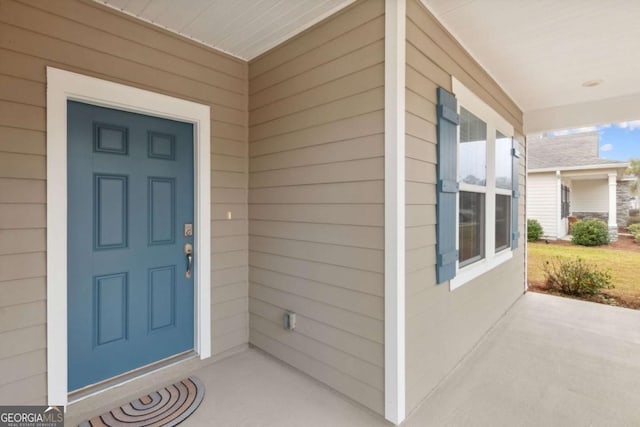 view of exterior entry with covered porch