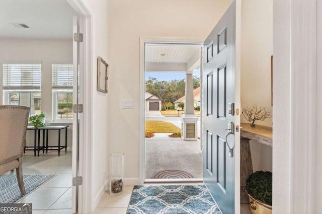 doorway featuring light tile patterned flooring