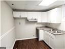 kitchen with white cabinetry, dark hardwood / wood-style flooring, and sink