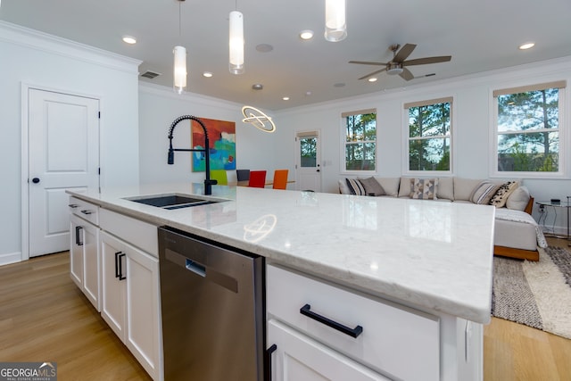 kitchen featuring sink, stainless steel dishwasher, decorative light fixtures, white cabinets, and light wood-type flooring