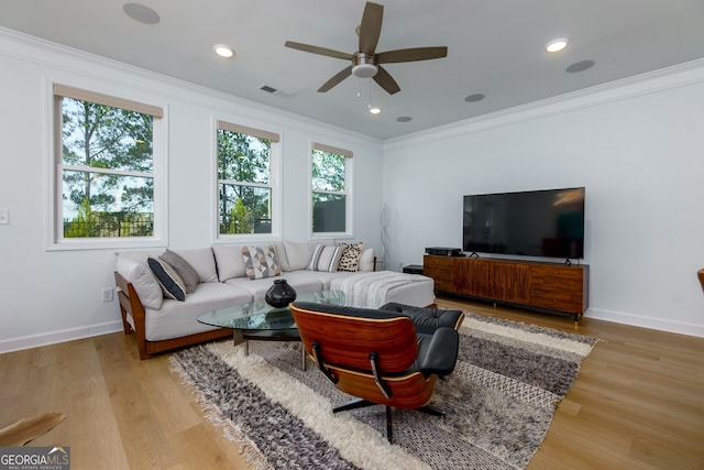 living room featuring hardwood / wood-style flooring, ceiling fan, and ornamental molding