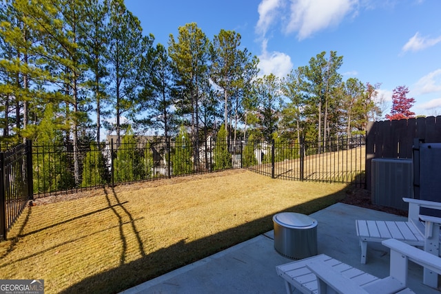 view of yard featuring central air condition unit and a patio area