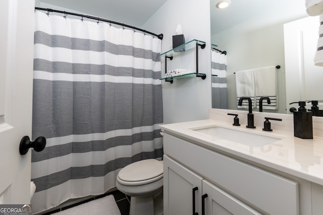 bathroom with tile patterned flooring, vanity, and toilet