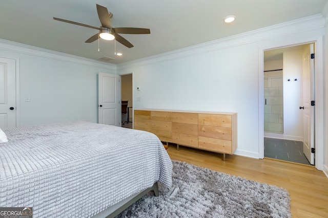 bedroom featuring hardwood / wood-style flooring, ceiling fan, crown molding, and ensuite bathroom