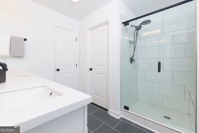 bathroom with tile patterned flooring, vanity, and an enclosed shower