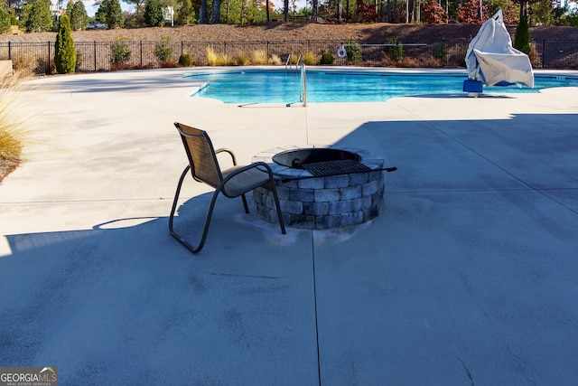 view of pool with a patio and an outdoor fire pit