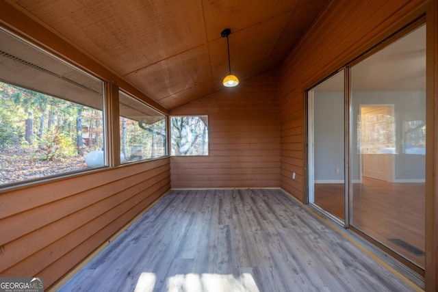 unfurnished sunroom with wood ceiling and lofted ceiling