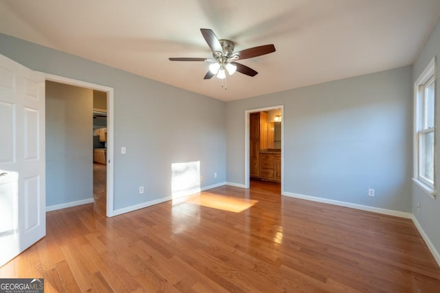 unfurnished bedroom with ceiling fan, connected bathroom, and light hardwood / wood-style flooring