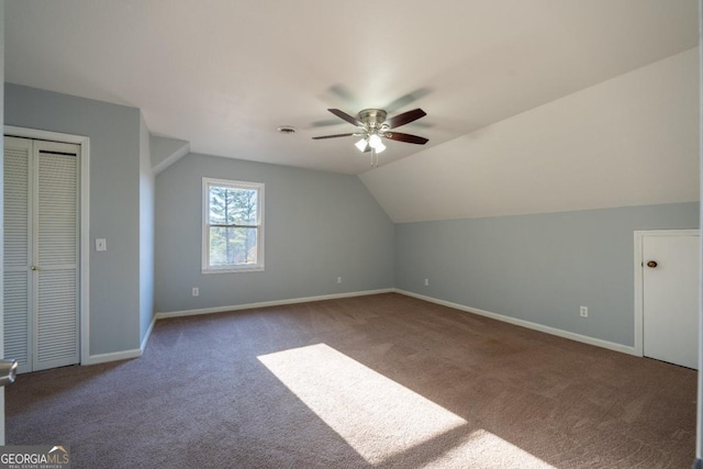 additional living space with carpet flooring, ceiling fan, and vaulted ceiling