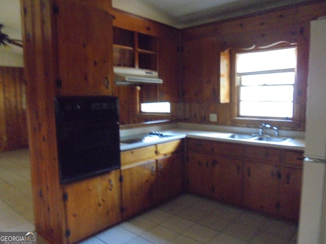 kitchen featuring sink, light tile patterned floors, range hood, wall oven, and stovetop