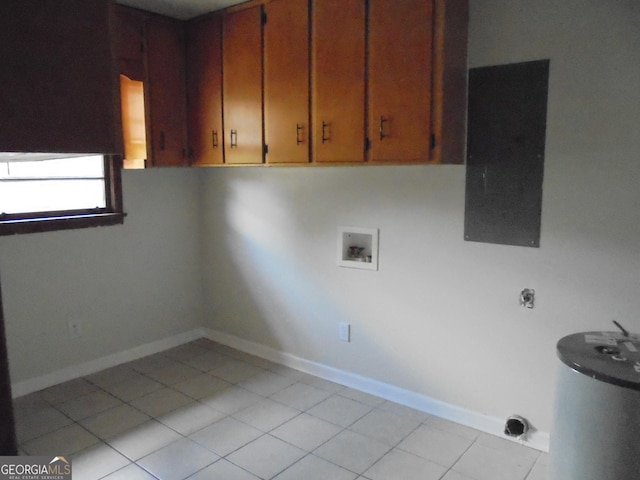 washroom featuring cabinets, washer hookup, and light tile patterned floors