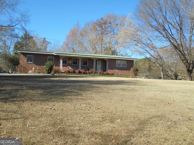 ranch-style home featuring a front yard