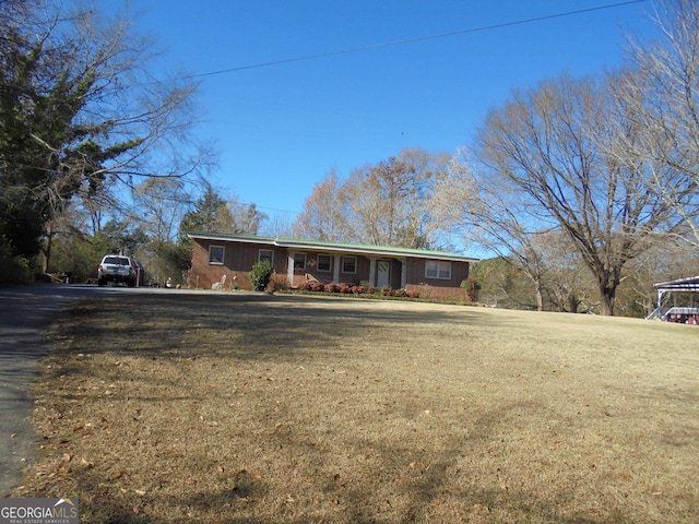 ranch-style home with a front lawn