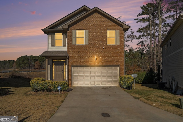 front of property with central AC, a yard, and a garage