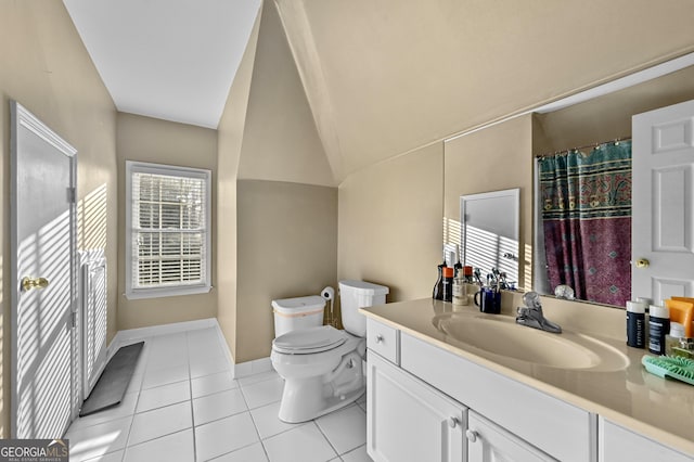 bathroom with tile patterned floors, vanity, toilet, and lofted ceiling