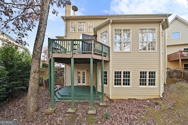 rear view of property with french doors and a wooden deck